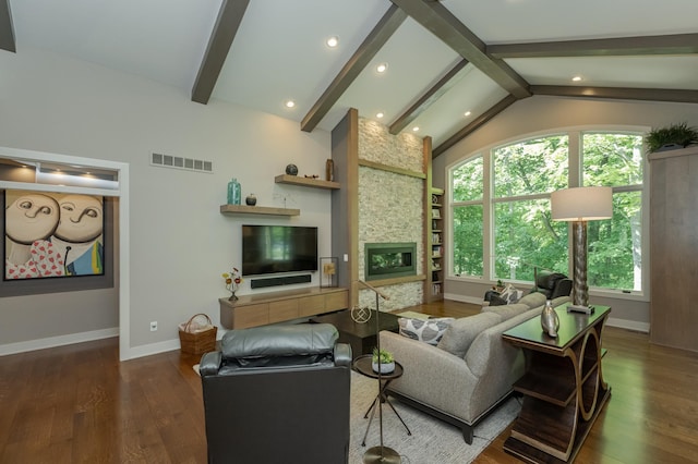 living room featuring visible vents, a fireplace, vaulted ceiling with beams, and wood finished floors