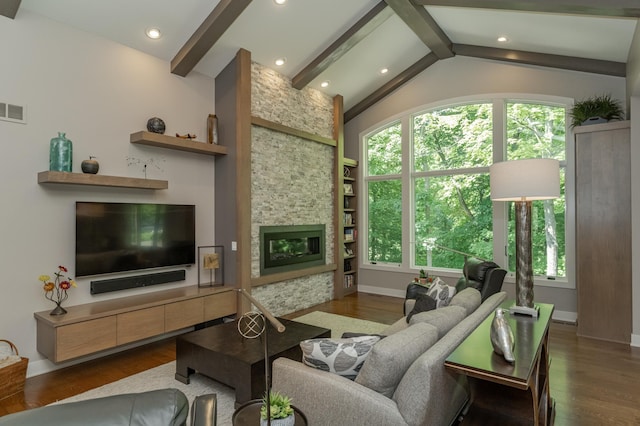 living room featuring built in shelves, a stone fireplace, wood finished floors, and vaulted ceiling with beams