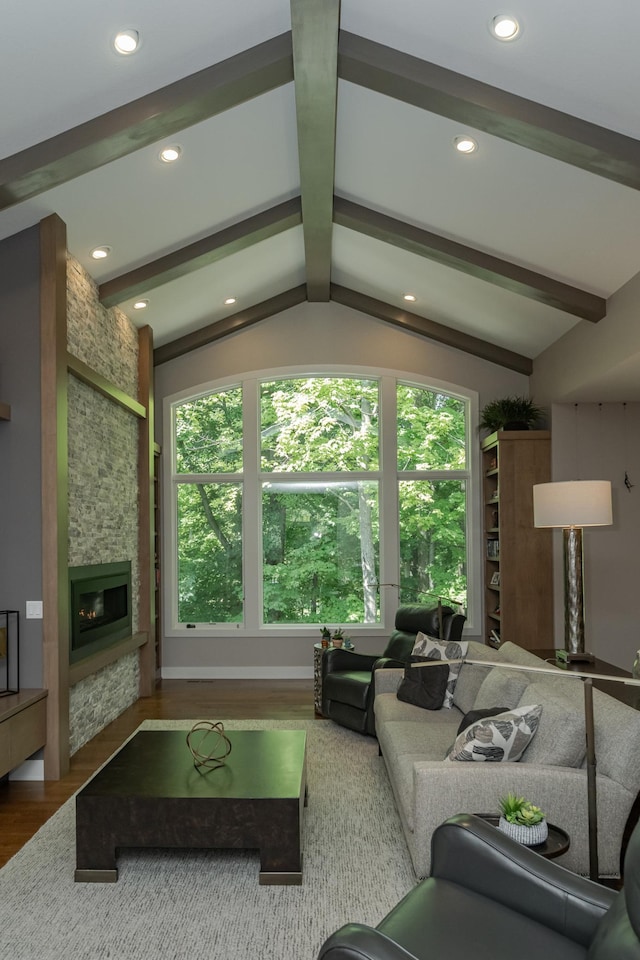 living area featuring recessed lighting, a fireplace, wood finished floors, and vaulted ceiling with beams