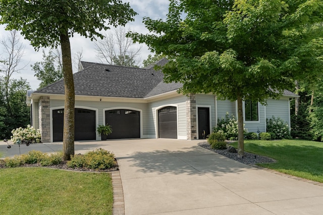 view of front of property with a front yard, driveway, a garage, and roof with shingles