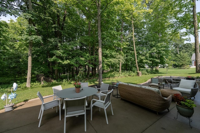 view of patio featuring outdoor dining area and an outdoor living space with a fire pit