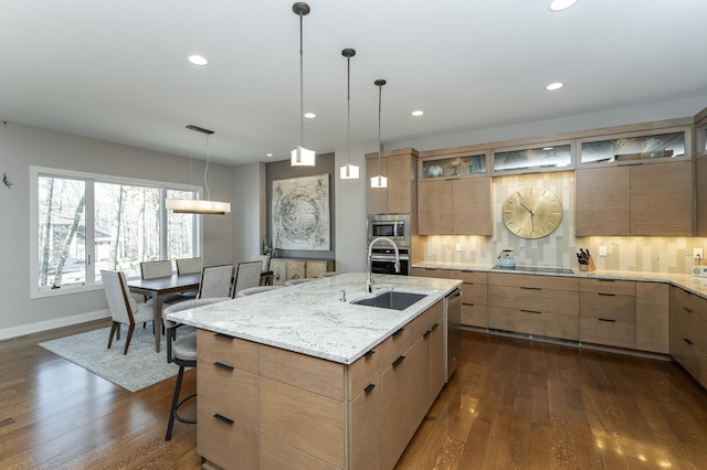 kitchen with a sink, stainless steel appliances, modern cabinets, dark wood finished floors, and recessed lighting