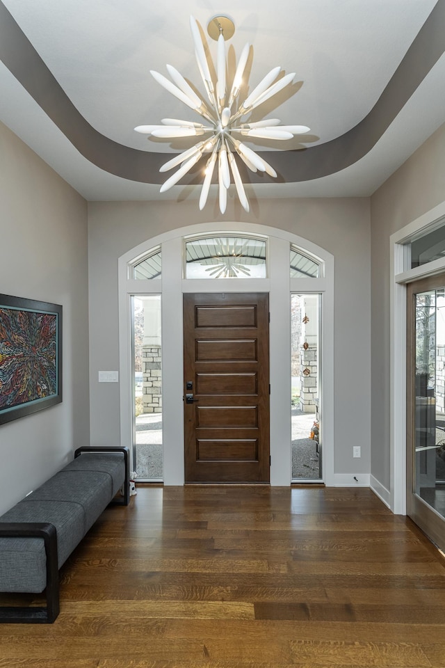 entrance foyer featuring wood finished floors and a chandelier