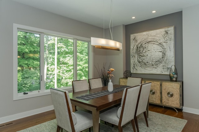 dining space with dark wood-type flooring, baseboards, and recessed lighting