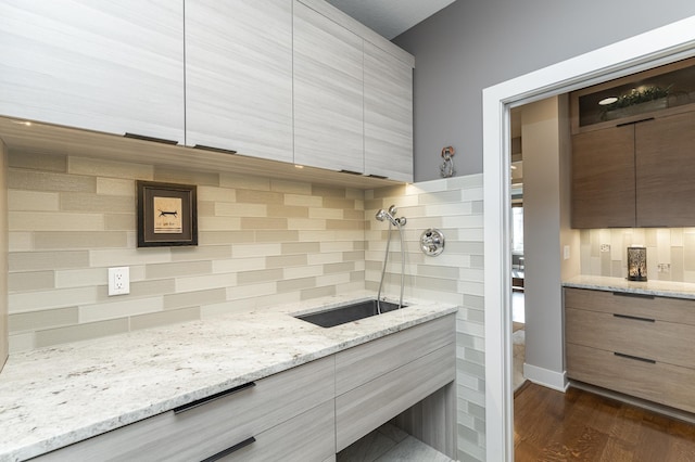 bathroom featuring tasteful backsplash, vanity, and wood finished floors