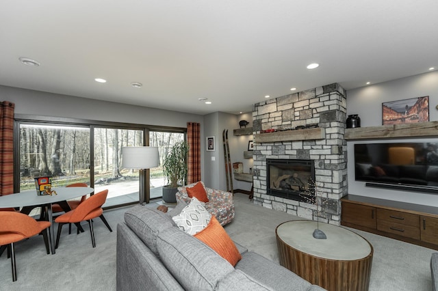 carpeted living area with a fireplace and recessed lighting