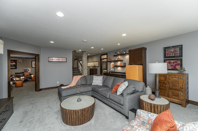 living room featuring light colored carpet, stairs, baseboards, recessed lighting, and a bar