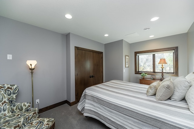 bedroom with dark carpet, recessed lighting, a closet, and baseboards