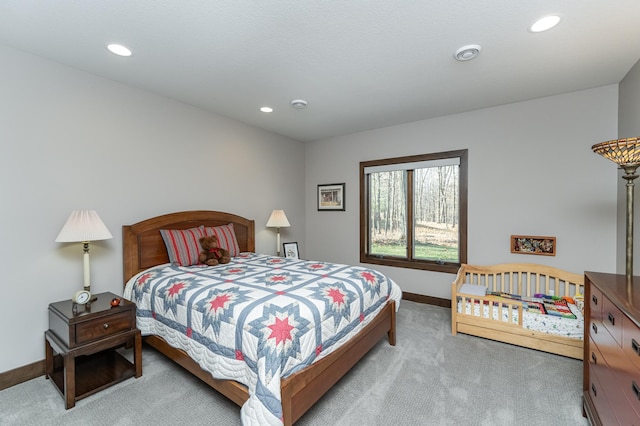 carpeted bedroom featuring baseboards and recessed lighting