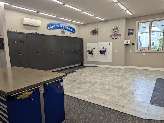 misc room featuring baseboards, a wall unit AC, and tile patterned flooring