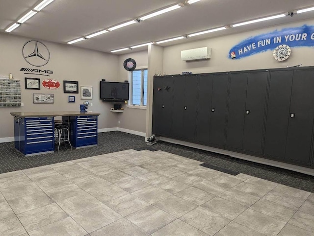 garage featuring an AC wall unit and baseboards