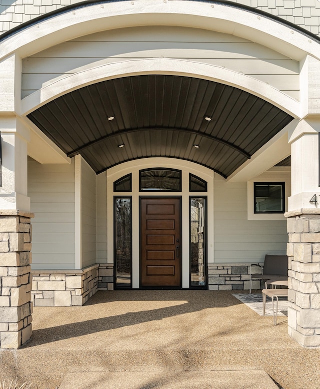 entrance to property featuring stone siding