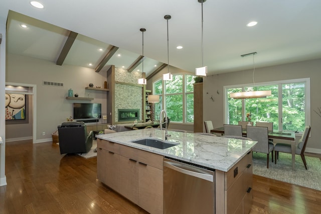 kitchen with a sink, dishwasher, baseboards, dark wood-style floors, and open floor plan