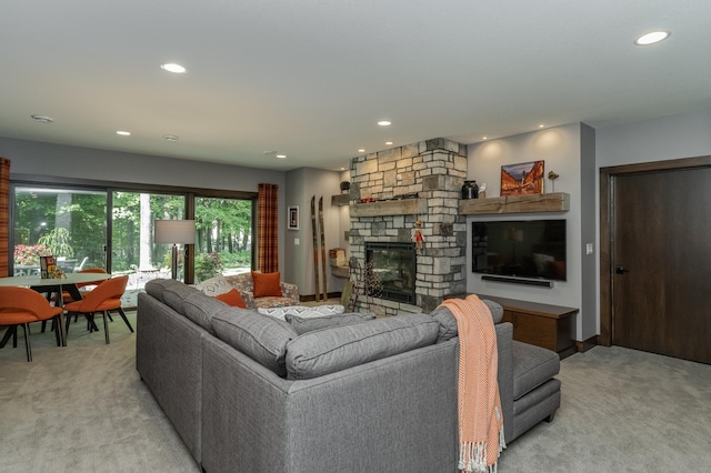 living room with light carpet, recessed lighting, and a stone fireplace