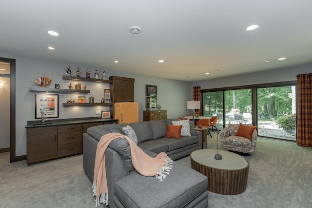 living area featuring light carpet, a dry bar, and recessed lighting