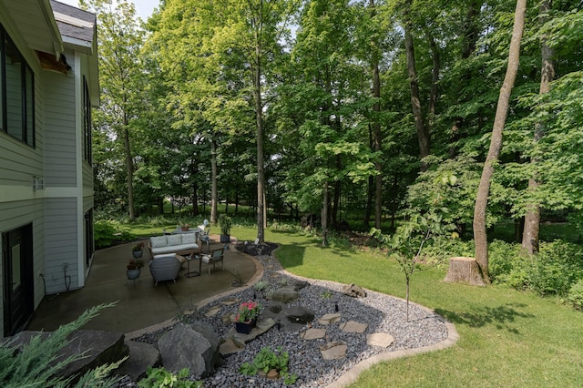 view of green lawn featuring a patio area