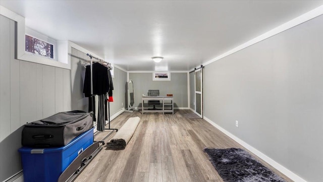 interior space with hardwood / wood-style floors, crown molding, and a baseboard heating unit