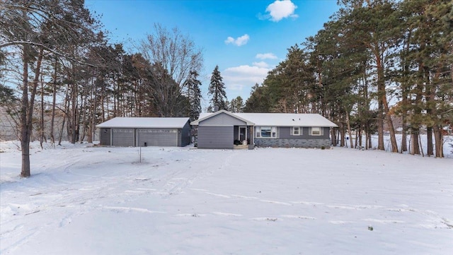 view of front of home with a garage and an outdoor structure