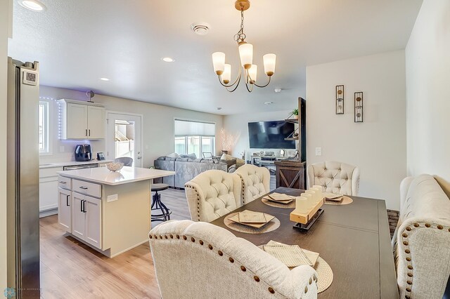 dining room with a notable chandelier and light hardwood / wood-style flooring