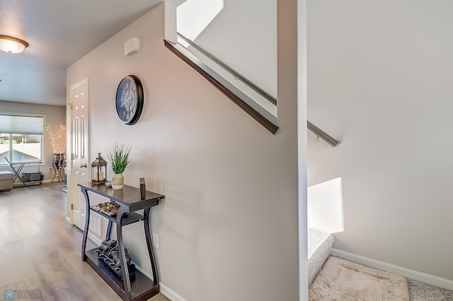 corridor with hardwood / wood-style floors