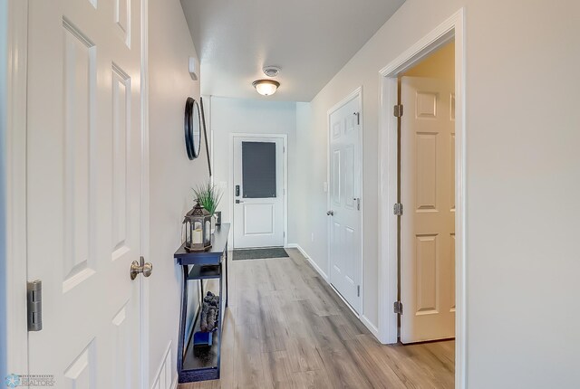 hallway with light wood-type flooring