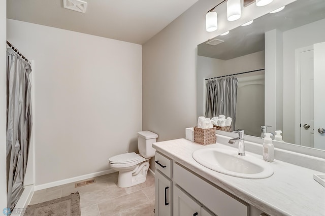 bathroom featuring vanity, a shower with shower curtain, tile patterned floors, and toilet