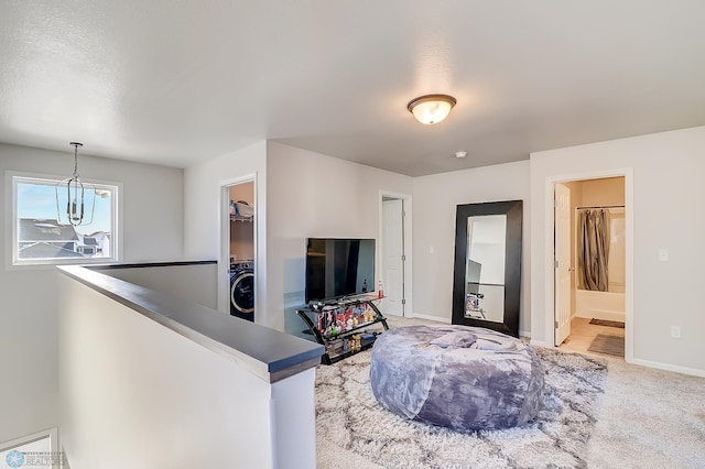 carpeted living room with washer / clothes dryer