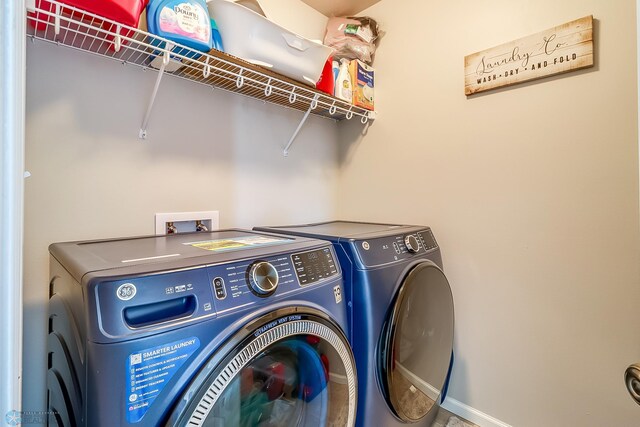 clothes washing area featuring washing machine and clothes dryer