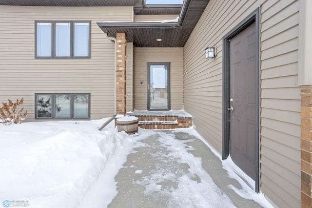 view of snow covered property entrance