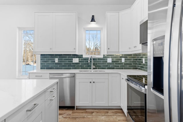 kitchen featuring white cabinetry, sink, and stainless steel appliances