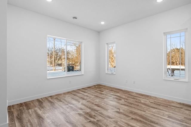 unfurnished room featuring light hardwood / wood-style floors