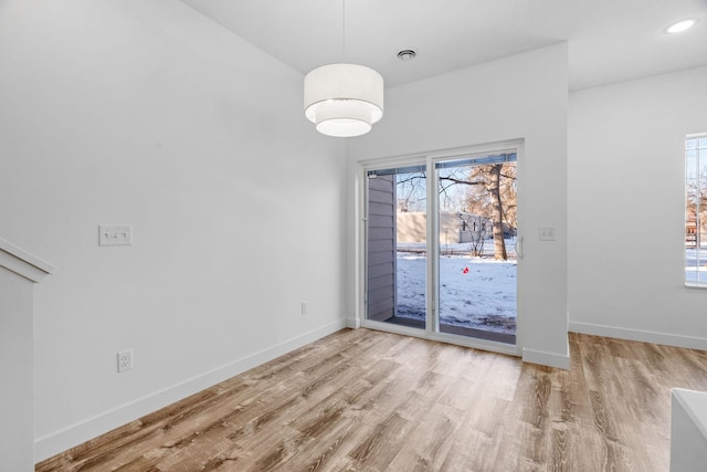 unfurnished dining area with light hardwood / wood-style flooring