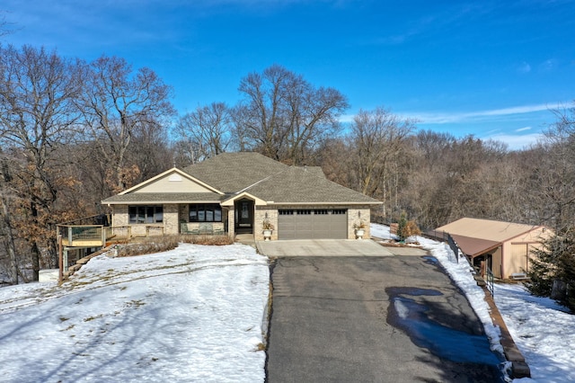 view of front of home featuring aphalt driveway, brick siding, a porch, a shingled roof, and a garage