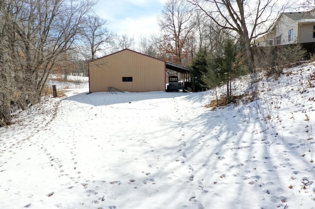 snowy yard with an outbuilding