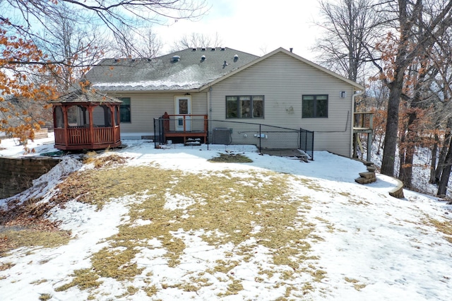 rear view of house featuring a wooden deck and a gazebo