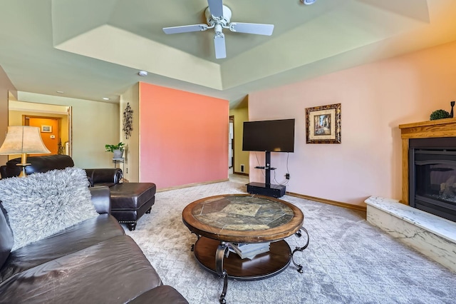 10740 230th St N, Scandia, MN 55073 - living room featuring a glass covered fireplace, ceiling fan, carpet floors, and a tray ceiling