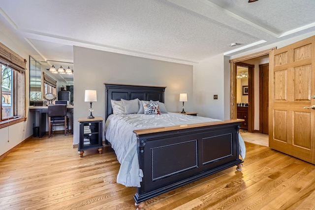 10740 230th St N, Scandia, MN 55073 - bedroom with light wood-type flooring and a textured ceiling