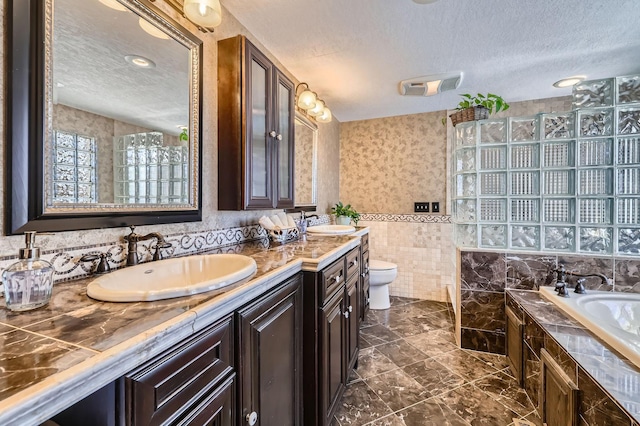 10740 230th St N, Scandia, MN 55073 - full bathroom featuring a textured ceiling, double vanity, a bath, tiled shower, and tile walls