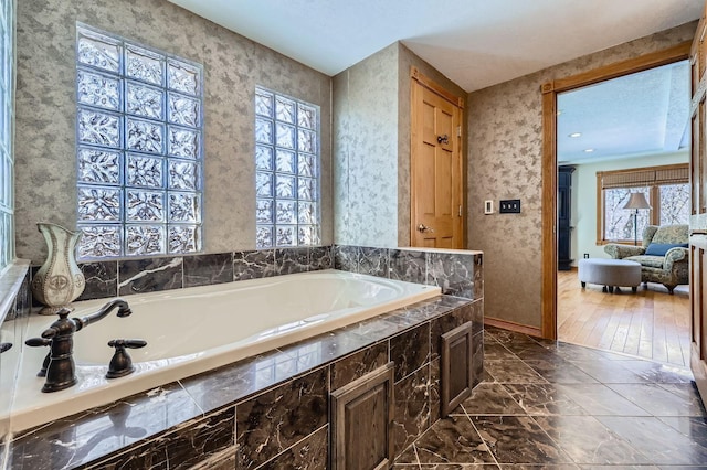 10740 230th St N, Scandia, MN 55073 - full bathroom with a garden tub and marble look tiles