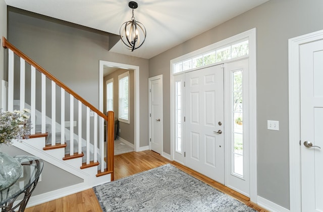 3942 Autumn Lake Ct SW, Rochester, MN 55902 - entryway with a chandelier, light wood-type flooring, and stairs