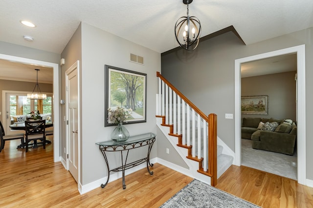 3942 Autumn Lake Ct SW, Rochester, MN 55902 - stairway featuring a chandelier, wood finished floors, and recessed lighting