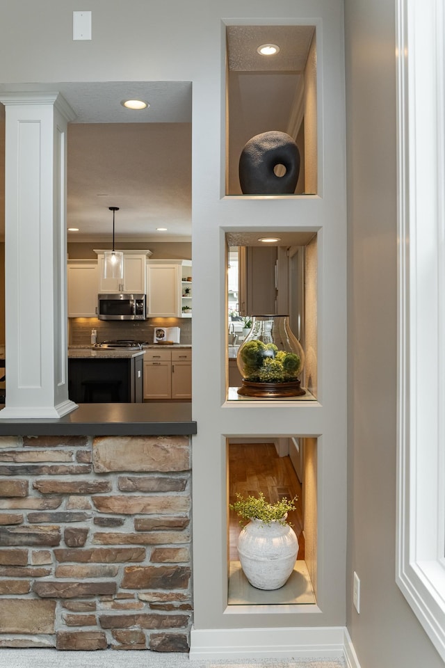 3942 Autumn Lake Ct SW, Rochester, MN 55902 - kitchen view of stainless steel microwave, recessed lighting, hanging light fixtures, decorative backsplash, and white cabinets