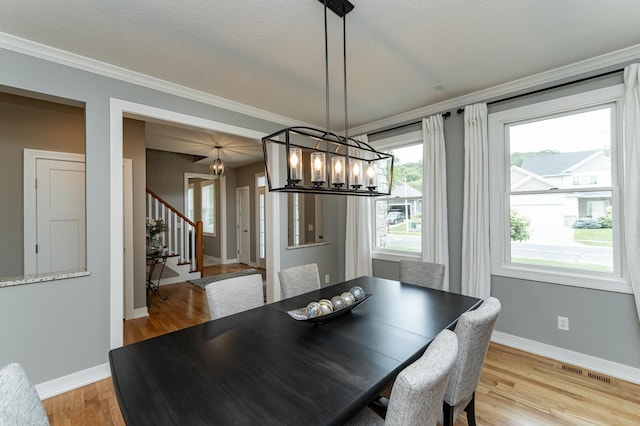 3942 Autumn Lake Ct SW, Rochester, MN 55902 - dining space with a chandelier, stairway, light wood finished floors, and ornamental molding