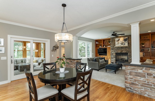 3942 Autumn Lake Ct SW, Rochester, MN 55902 - dining room with decorative columns, ceiling fan, light wood finished floors, crown molding, and arched walkways