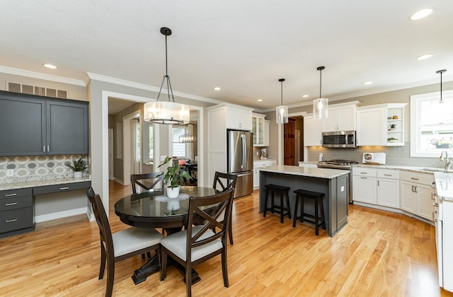 3942 Autumn Lake Ct SW, Rochester, MN 55902 - dining area with ornamental molding, light wood finished floors, recessed lighting, a chandelier, and a desk