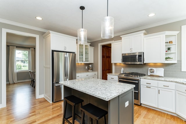 3942 Autumn Lake Ct SW, Rochester, MN 55902 - kitchen featuring stainless steel appliances, open shelves, a center island, white cabinetry, and tasteful backsplash