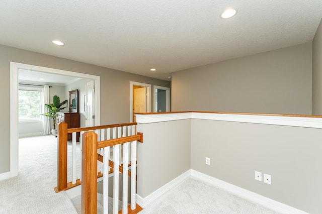 3942 Autumn Lake Ct SW, Rochester, MN 55902 - hallway with an upstairs landing, light colored carpet, and recessed lighting