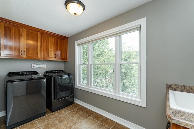 3942 Autumn Lake Ct SW, Rochester, MN 55902 - laundry area with cabinet space, washer and dryer, and tile patterned floors