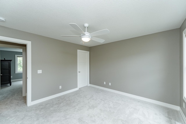 3942 Autumn Lake Ct SW, Rochester, MN 55902 - empty room with light colored carpet, a ceiling fan, a textured ceiling, and a smoke detector