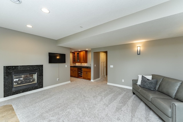 3942 Autumn Lake Ct SW, Rochester, MN 55902 - living area featuring light colored carpet, wet bar, recessed lighting, and a premium fireplace